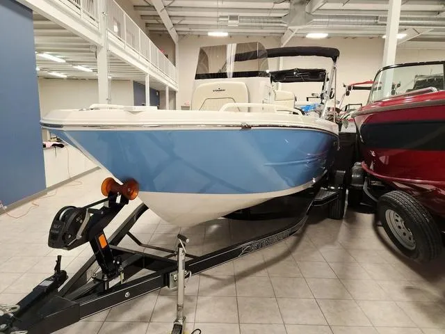 Slide: The Image of 2023 Stingray 173CC boat on trailer in showroom with Mercury outboard motor. - 3