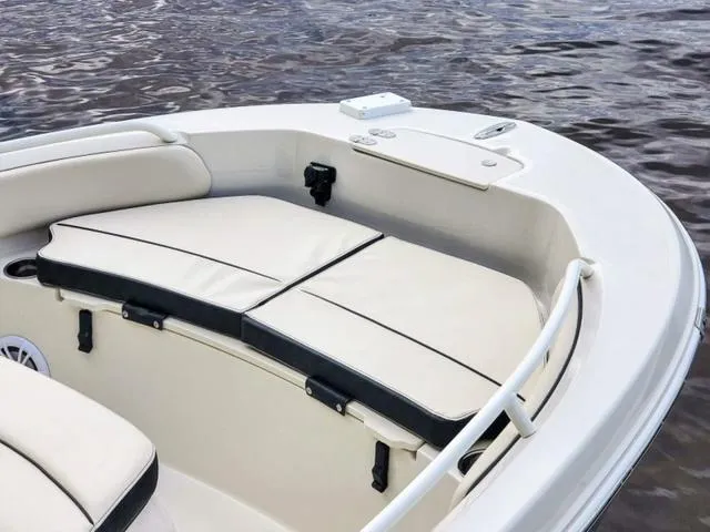 Slide: The Image of 2023 Stingray 173CC boat interior with cushioned seating on calm water. - 33