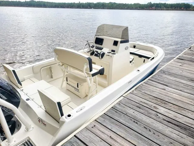 Slide: The Image of 2023 Stingray 173CC boat docked by a wooden pier on a calm lake. - 35