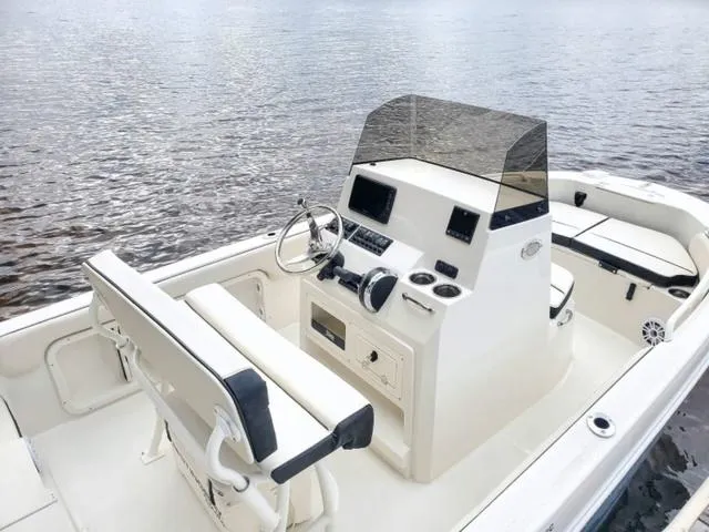 Slide: The Image of 2023 Stingray 173CC boat interior with console and seating, on calm water. - 37