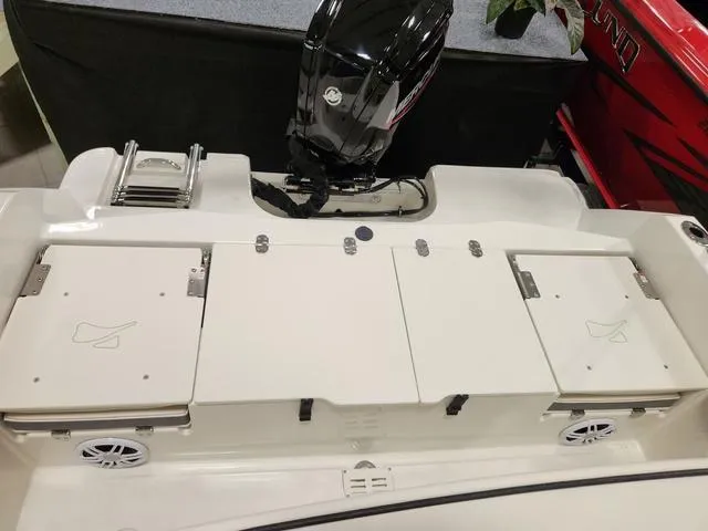 Slide: The Image of 2023 Stingray 173CC boat stern with outboard motor and storage compartments. - 7