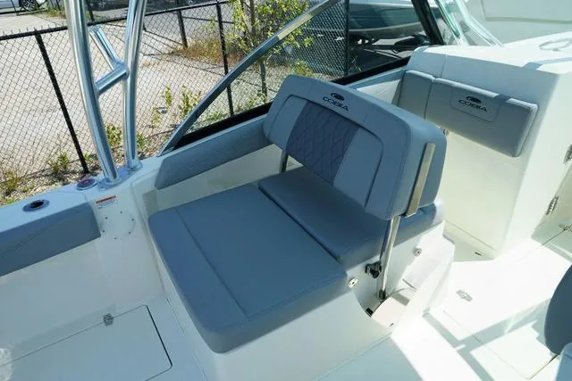 Slide: The Image of 2024 Cobia 240 DC boat interior with gray seating and modern design. - 13
