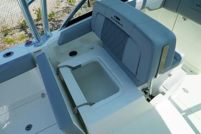 Slide: The Image of 2024 Cobia 240 DC boat interior with seating and storage compartment. - 15