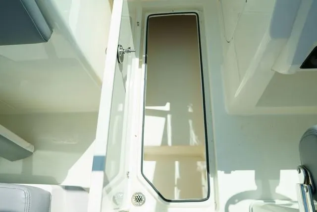 Slide: The Image of 2024 Cobia 240 DC boat interior with open storage compartment. - 17