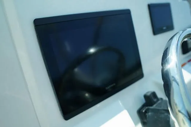 Slide: The Image of 2024 Cobia 240 DC dashboard with modern touchscreen display and steering wheel. - 21