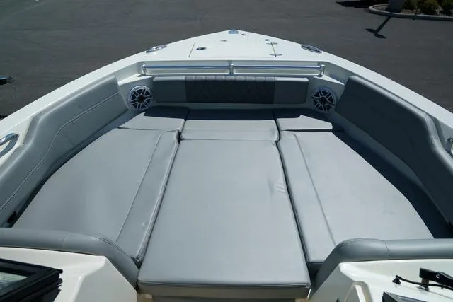 Slide: The Image of 2024 Cobia 240 DC boat with spacious cushioned seating area. - 25