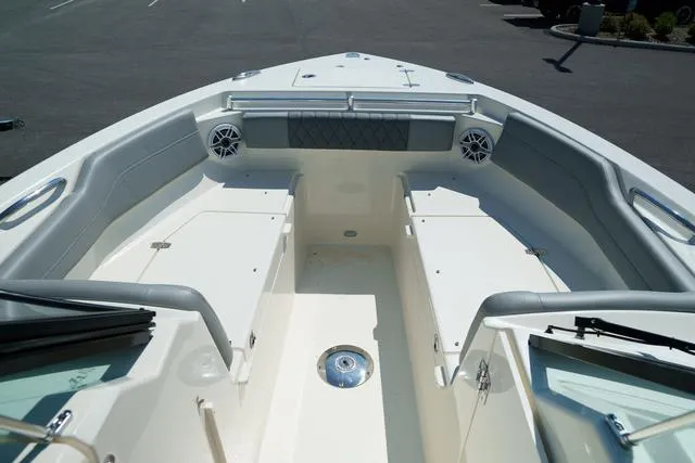 Slide: The Image of 2024 Cobia 240 DC boat interior with seating and speakers. - 26
