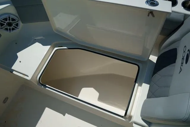 Slide: The Image of 2024 Cobia 240 DC boat storage compartment with open hatch. - 28