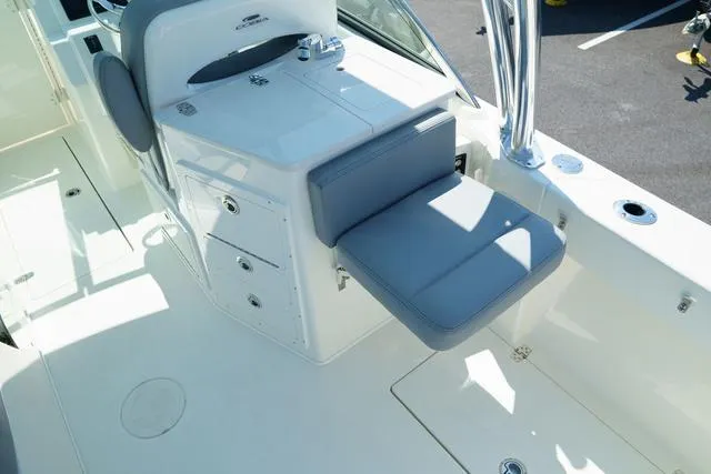Slide: The Image of 2024 Cobia 240 DC boat interior with seating and storage compartments. - 9