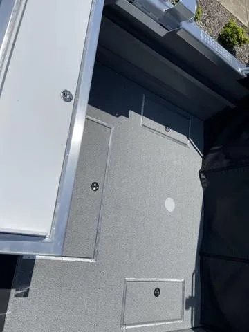 Slide: The Image of 2024 Thunder Jet Alexis OS 22' boat interior with storage compartments. - 10