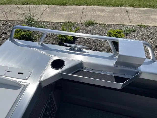 Slide: The Image of 2024 Thunder Jet Alexis OS 22' boat interior detail with cup holder and storage. - 14