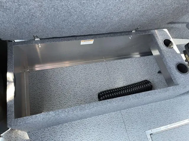Slide: The Image of 2024 Thunder Jet Alexis OS 22' storage compartment with cup holders and coiled hose. - 27