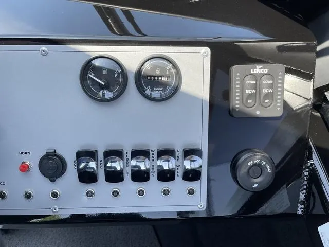 Slide: The Image of Control panel of 2024 Thunder Jet Alexis OS 22' boat with gauges and switches. - 32