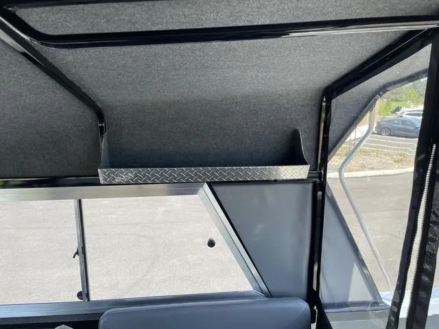 Slide: The Image of Interior view of 2024 Thunder Jet Alexis OS 22' boat with storage shelf. - 38