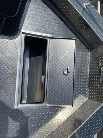 Slide: The Image of 2024 Thunder Jet Alexis OS 22' boat storage compartment with diamond plate flooring. - 40