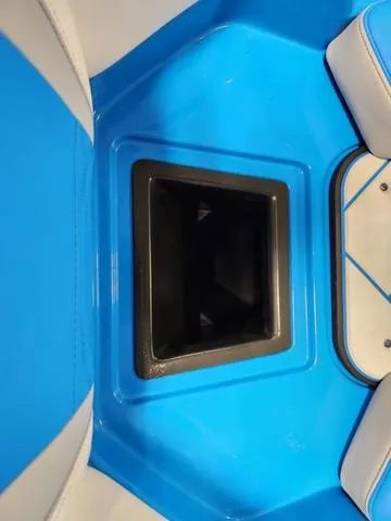 Slide: The Image of 2023 Malibu 26 LSV boat interior with blue and white seating. - 13