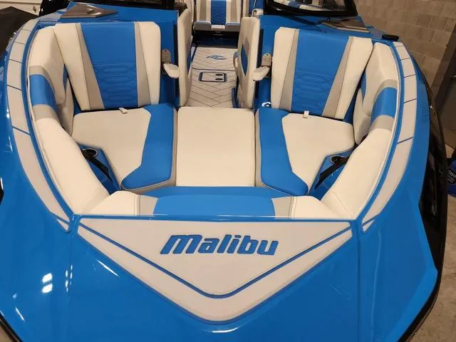 Slide: The Image of 2023 Malibu 26 LSV boat with blue and white interior seating. - 15