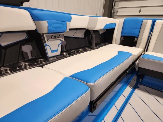 Slide: The Image of 2023 Malibu 26 LSV boat interior with blue and white seating. - 20