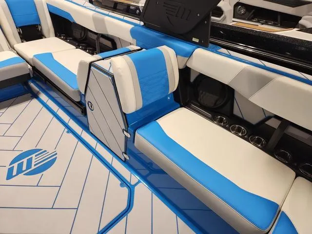 Slide: The Image of 2023 Malibu 26 LSV boat interior with blue and white seating. - 31