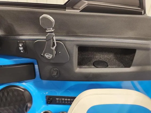 Slide: The Image of Interior detail of 2023 Malibu 26 LSV boat showing control panel and storage compartment. - 39