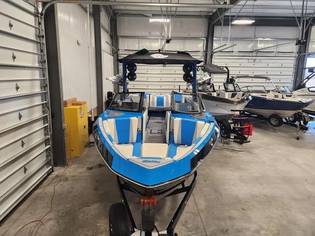 Slide: The Image of 2023 Malibu 26 LSV boat in a storage facility. - 45
