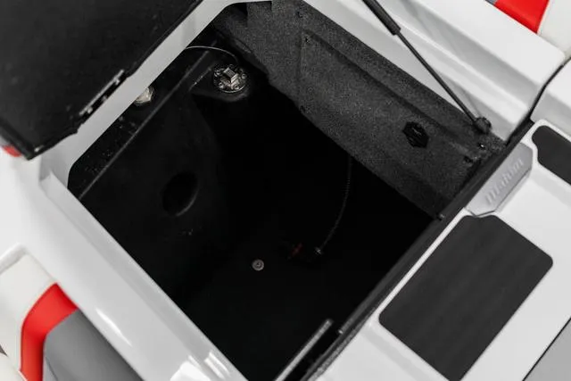 Slide: The Image of 2024 Malibu 23 LSV storage compartment with open hatch. - 12