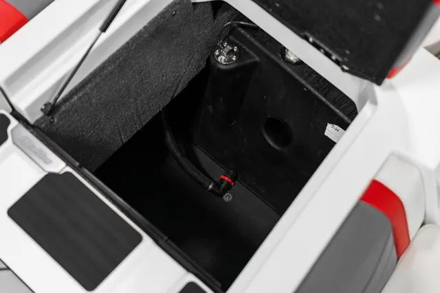 Slide: The Image of 2024 Malibu 23 LSV storage compartment with open lid. - 13