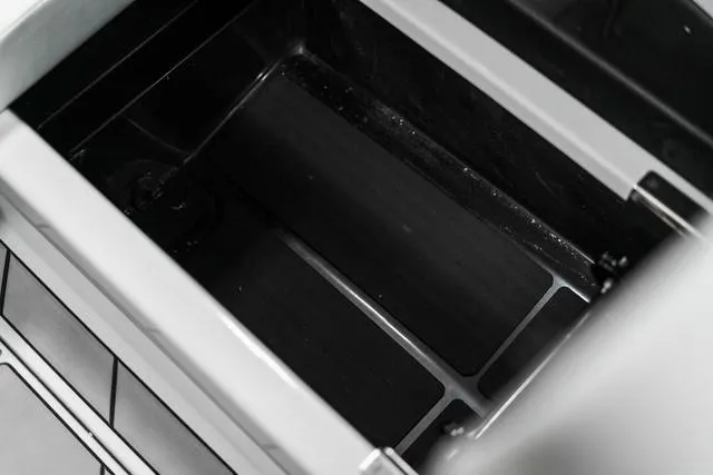 Slide: The Image of 2024 Malibu 23 LSV boat storage compartment with cup holders. - 20