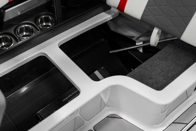 Slide: The Image of 2024 Malibu 23 LSV boat interior storage compartment with red and white upholstery. - 22