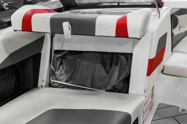 Slide: The Image of Open storage compartment of 2024 Malibu 23 LSV boat. - 23