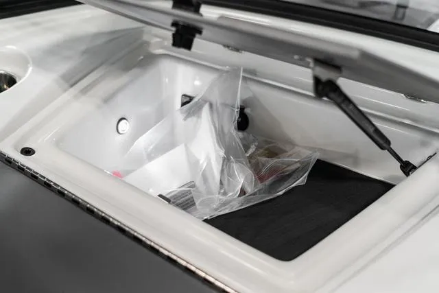 Slide: The Image of 2024 Malibu 23 LSV boat interior with red, white, and gray seating. - 24