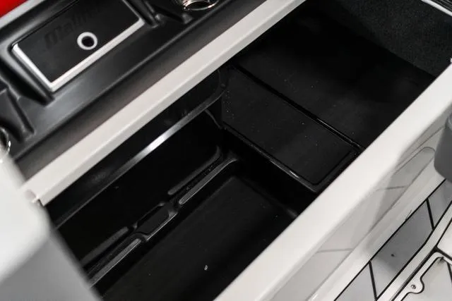 Slide: The Image of 2024 Malibu 23 LSV boat dashboard with digital displays and steering wheel. - 27