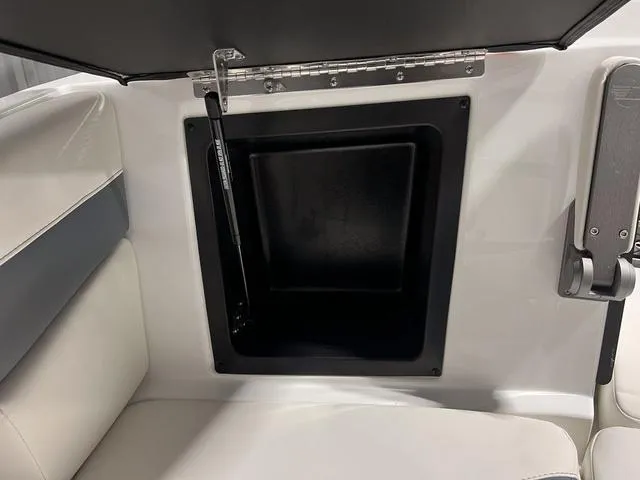 Slide: The Image of 2024 Malibu 23 LSV boat interior with white, gray, and red upholstery. - 37