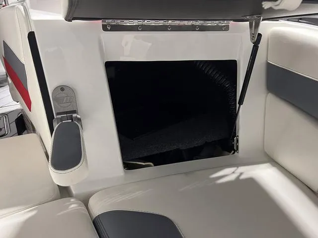 Slide: The Image of 2024 Malibu 23 LSV boat with black cover in a garage. - 39