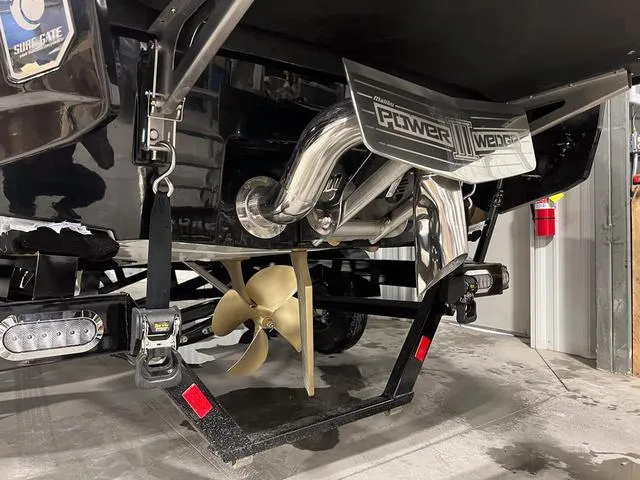 Slide: The Image of 2024 Malibu 23 LSV boat interior with red, white, and gray seating. - 7