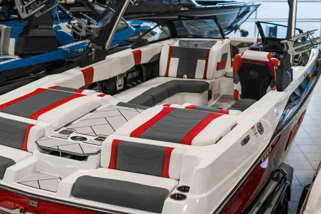 Slide: The Image of 2024 Malibu 23 LSV boat interior with red, gray, and white seating. - 8