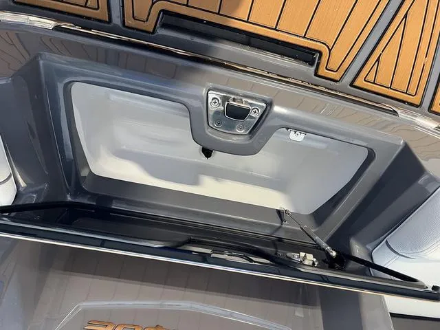 Slide: The Image of 2024 Nautique Super Air Nautique G23 storage compartment with teak flooring. - 10