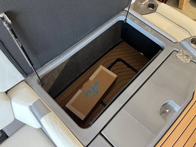 Slide: The Image of Open storage compartment in 2024 Nautique Super Air Nautique G23 boat. - 15
