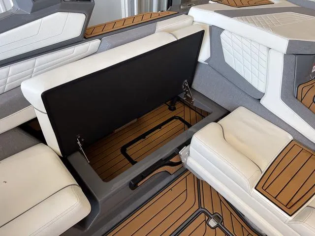 Slide: The Image of 2024 Nautique Super Air Nautique G23 interior seating and storage compartment. - 18
