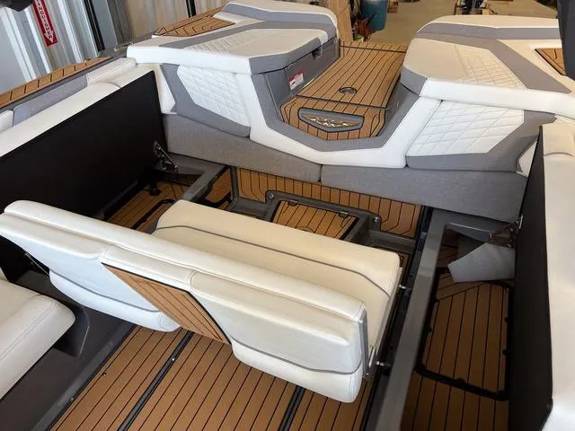 Slide: The Image of 2024 Nautique Super Air Nautique G23 interior with luxurious seating and teak flooring. - 21