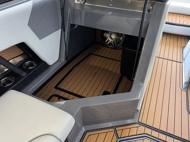 Slide: The Image of 2024 Nautique Super Air Nautique G23 interior with teak flooring and modern seating. - 23