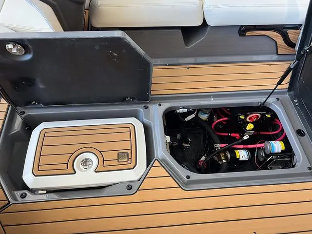 Slide: The Image of 2024 Nautique Super Air Nautique G23 storage and engine compartment. - 24