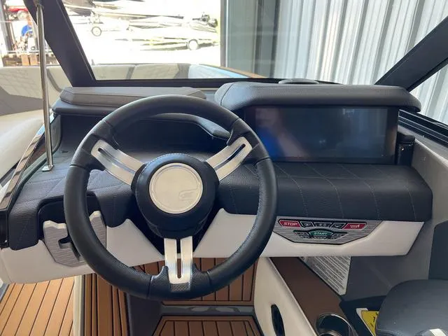 Slide: The Image of 2024 Nautique Super Air Nautique G23 dashboard with steering wheel and touchscreen display. - 26