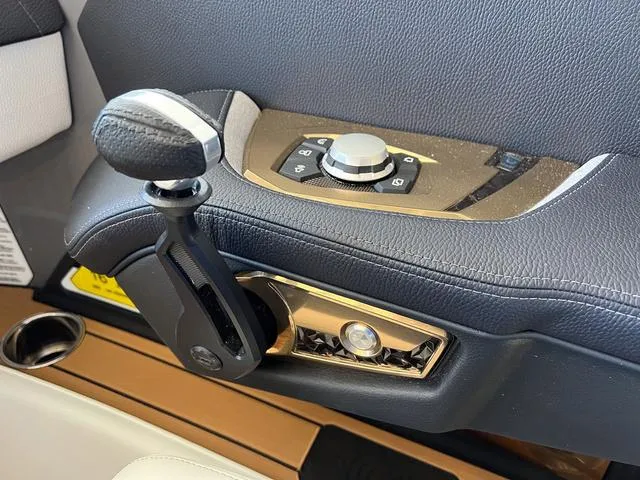 Slide: The Image of Close-up of 2024 Nautique Super Air Nautique G23 control panel and throttle. - 28