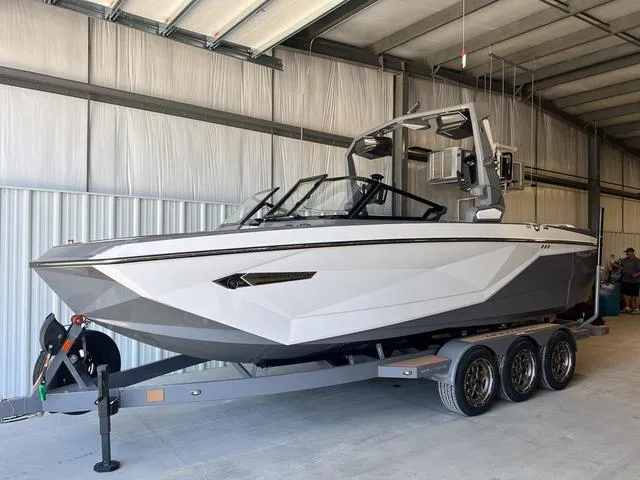 Slide: The Image of 2024 Nautique Super Air Nautique G23 boat on a trailer in a storage facility. - 3