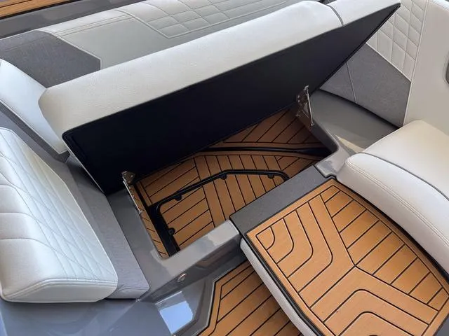 Slide: The Image of 2024 Nautique Super Air Nautique G23 interior storage compartment with cushioned seating. - 32