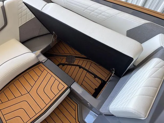 Slide: The Image of 2024 Nautique Super Air Nautique G23 interior storage compartment with teak flooring. - 33