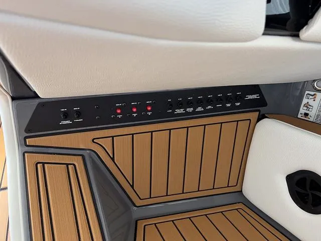 Slide: The Image of 2024 Nautique Super Air Nautique G23 control panel with wood accents. - 43