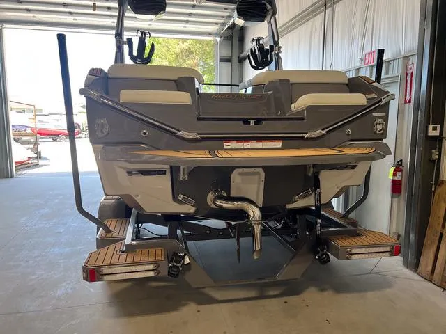 Slide: The Image of 2024 Nautique Super Air Nautique G23 boat rear view in a garage. - 6