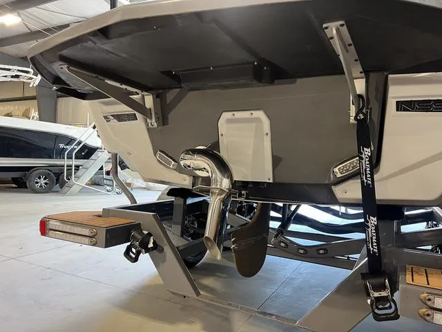 Slide: The Image of 2024 Nautique Super Air Nautique G23 boat rear view in a showroom. - 7